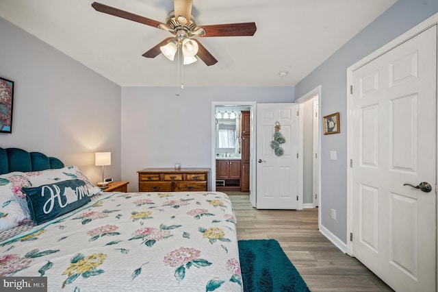 bedroom featuring ceiling fan, connected bathroom, and light wood-type flooring