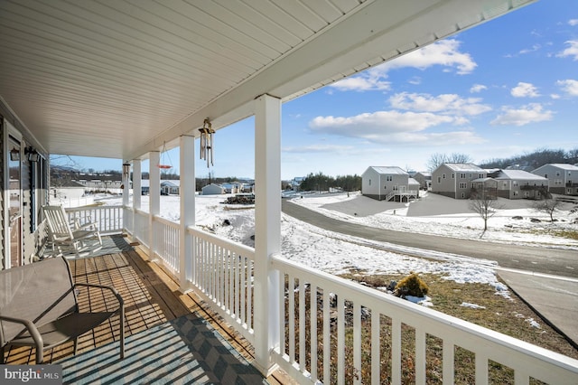 view of snow covered back of property