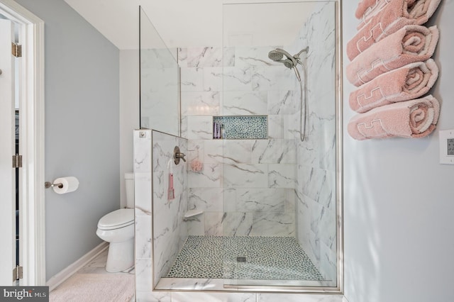 bathroom featuring toilet and an enclosed shower