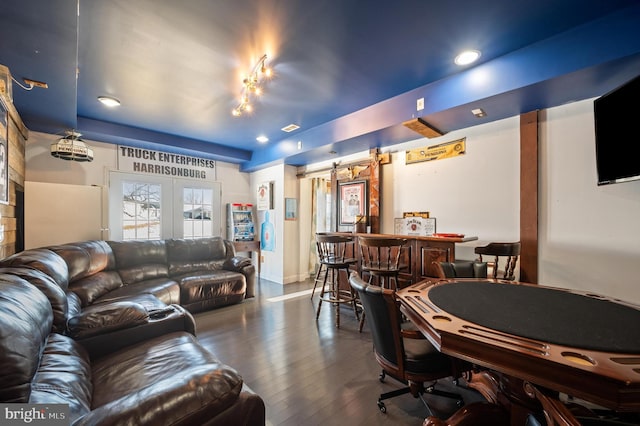 living room with a barn door and hardwood / wood-style flooring