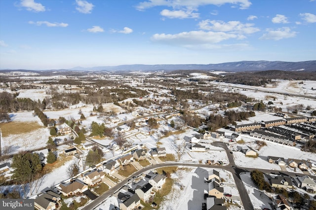 snowy aerial view with a mountain view