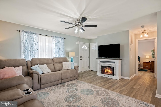 living room featuring light hardwood / wood-style floors and ceiling fan