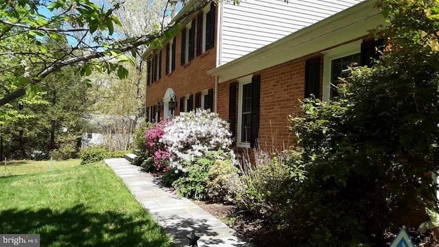 view of home's exterior featuring a yard