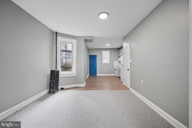 unfurnished room with carpet floors and baseboards