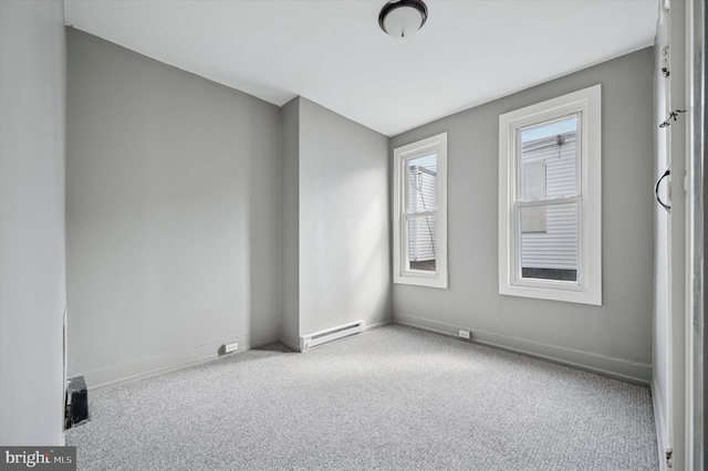 spare room featuring carpet, a baseboard radiator, and baseboards