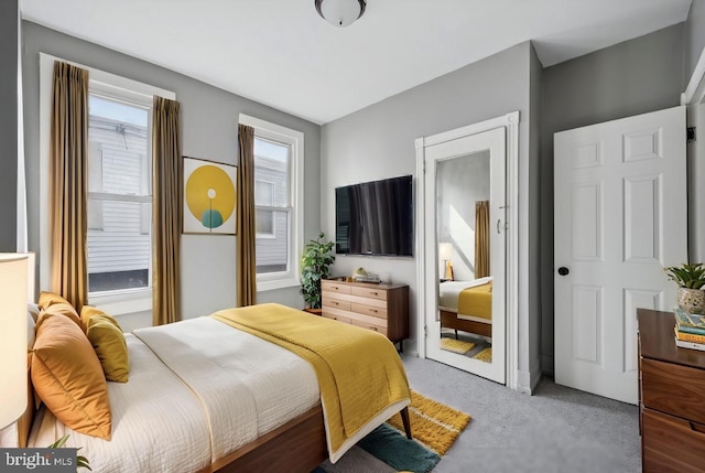 bedroom featuring light colored carpet