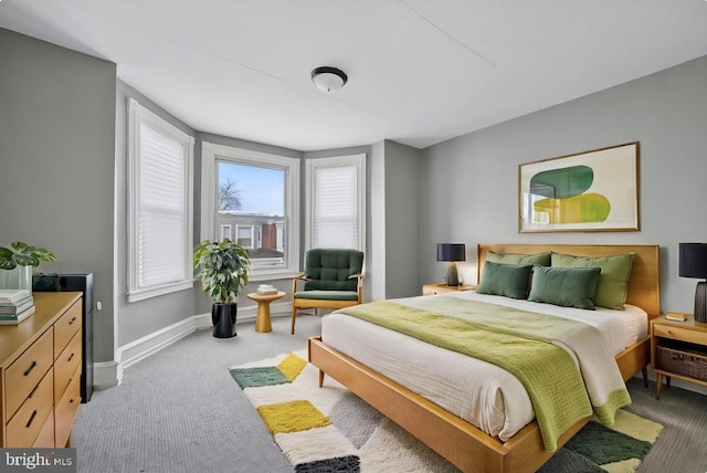 bedroom featuring light carpet and baseboards