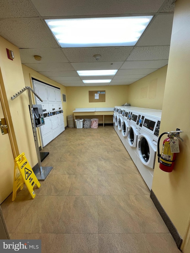 clothes washing area with washer and dryer and stacked washer / dryer