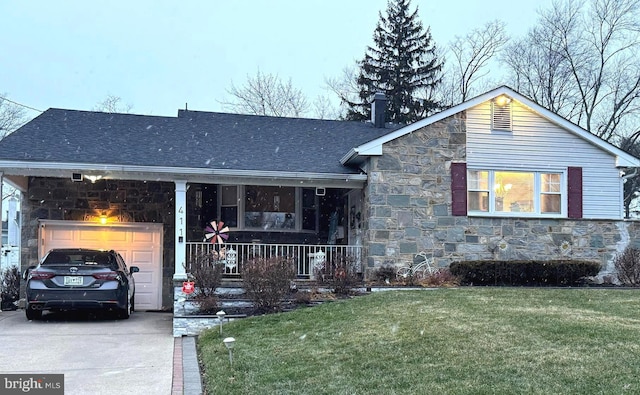 view of front of house with a shingled roof, concrete driveway, a front lawn, a garage, and stone siding