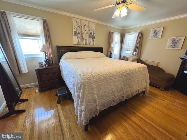 bedroom featuring ornamental molding, a ceiling fan, and hardwood / wood-style floors