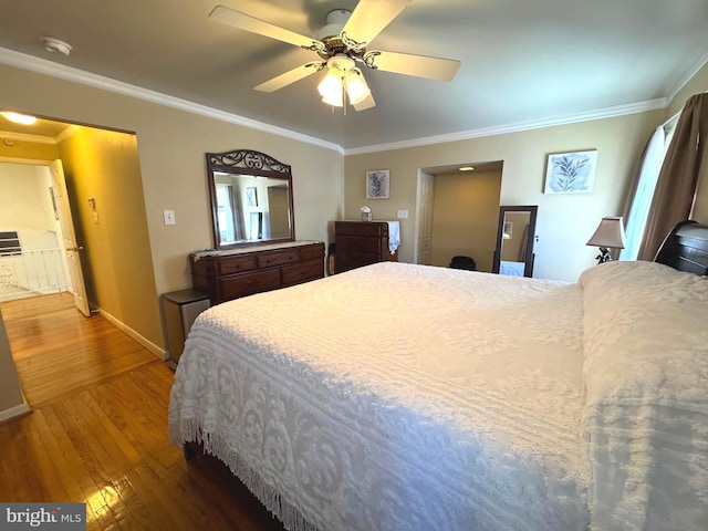 bedroom featuring ornamental molding, a ceiling fan, baseboards, and hardwood / wood-style flooring