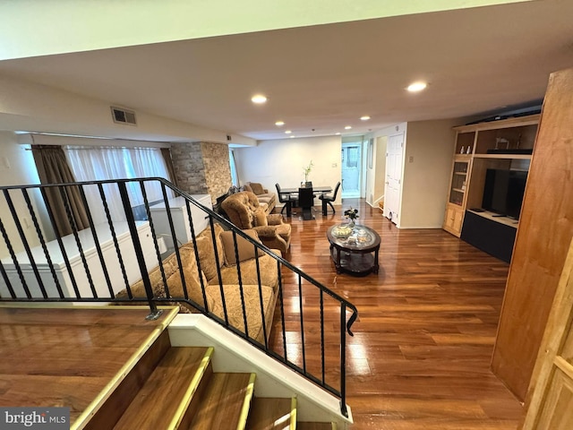 stairs featuring visible vents, recessed lighting, and wood finished floors