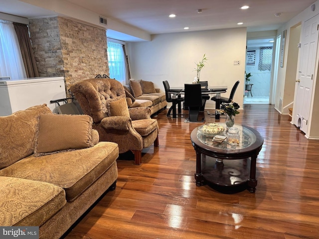 living area with recessed lighting, wood finished floors, and visible vents