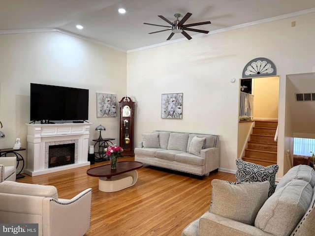 living room with visible vents, stairs, and ornamental molding