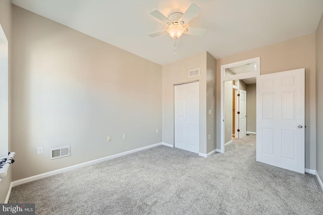 unfurnished bedroom with light carpet, a closet, and ceiling fan