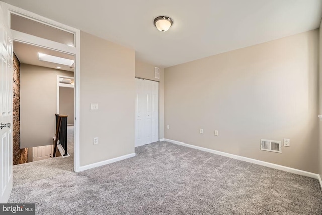 unfurnished bedroom with carpet flooring and a closet