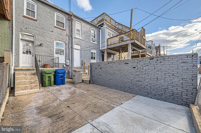 back of house featuring central air condition unit and a patio