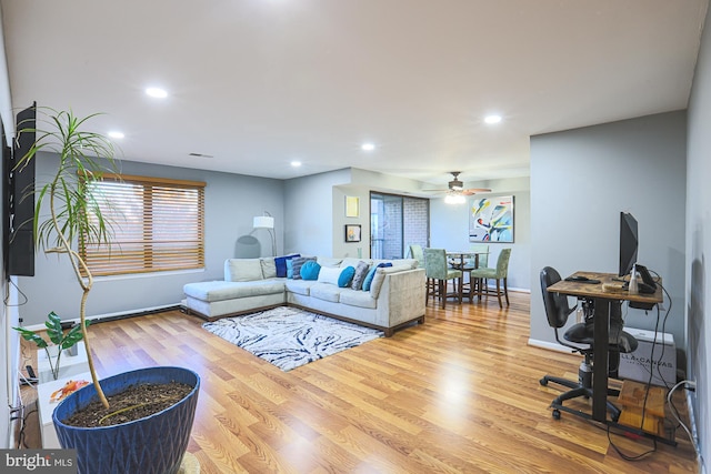 living room with ceiling fan and light hardwood / wood-style floors