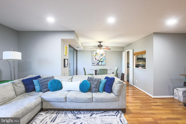 living room with ceiling fan and wood-type flooring