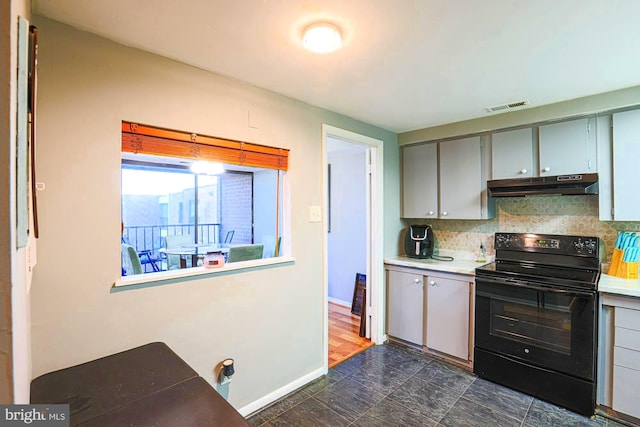 kitchen with backsplash, black / electric stove, and gray cabinets