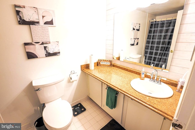 bathroom featuring tile patterned flooring, vanity, toilet, and curtained shower