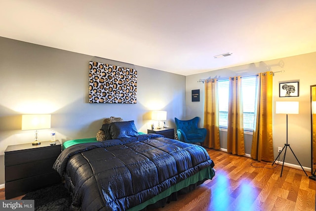 bedroom with wood-type flooring