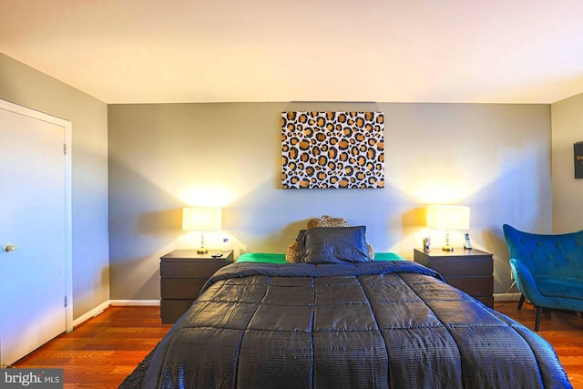 bedroom with dark hardwood / wood-style flooring