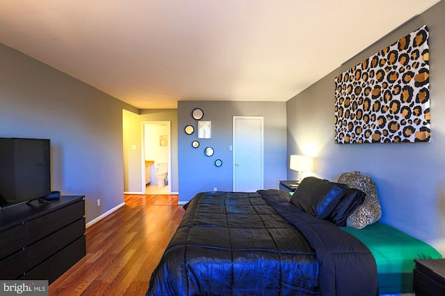 bedroom with hardwood / wood-style flooring