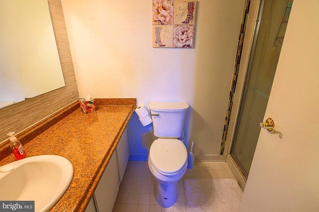 bathroom featuring tile patterned floors, vanity, toilet, and a shower with door