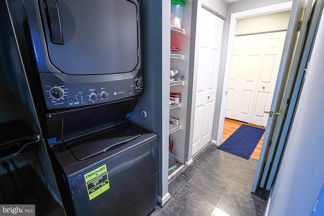 laundry area with stacked washer / drying machine