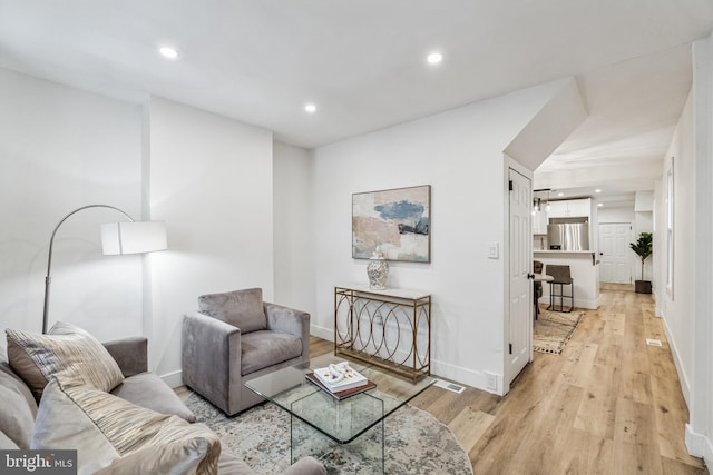 living room with light hardwood / wood-style flooring