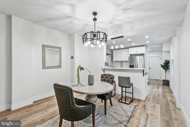 dining area featuring a chandelier and light hardwood / wood-style floors