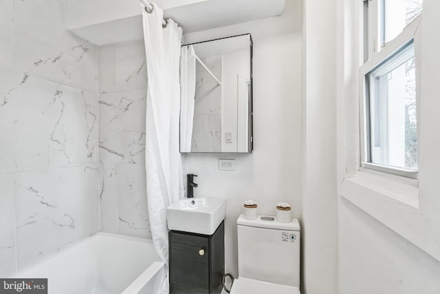 full bathroom with shower / bath combo, vanity, and toilet