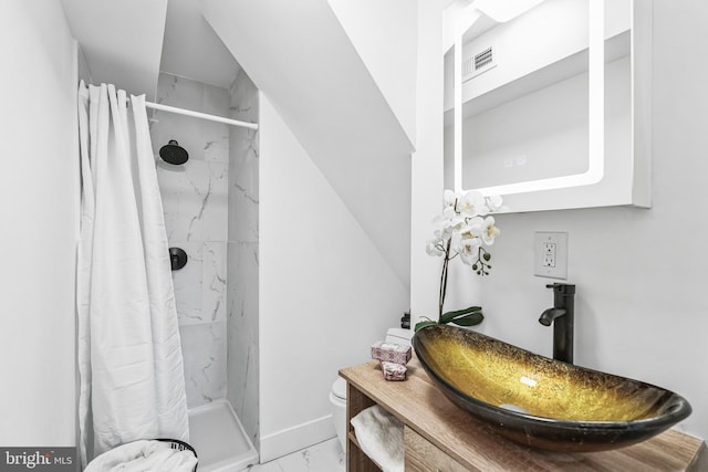 bathroom featuring vanity, toilet, and curtained shower