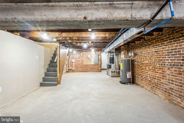 basement featuring electric panel, heating unit, and water heater