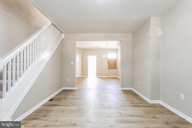 interior space featuring light hardwood / wood-style flooring and an inviting chandelier