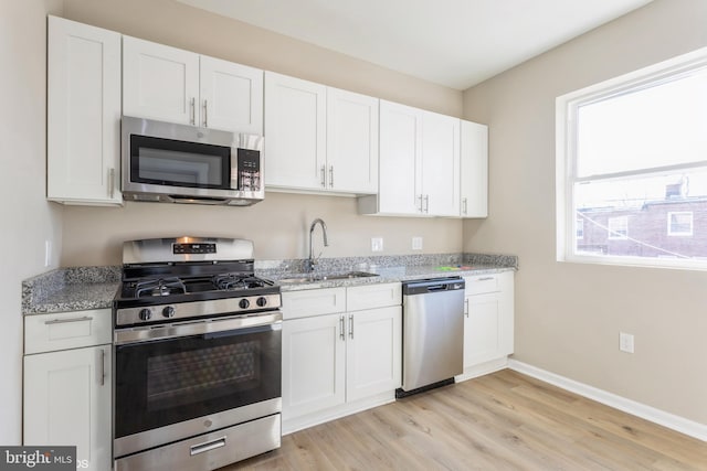 kitchen with stainless steel appliances and white cabinetry