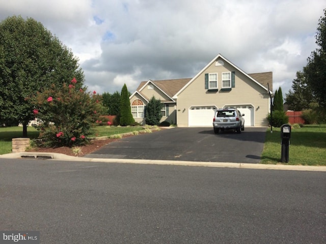 view of front facade featuring a garage and a front lawn