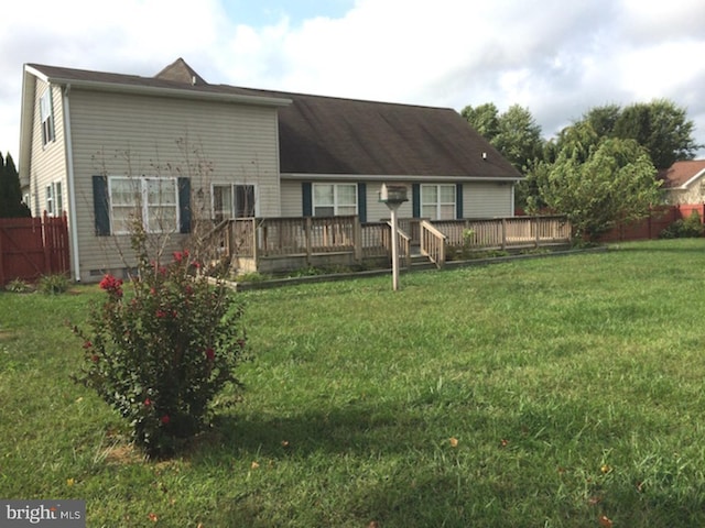 view of front facade with a front yard and a deck