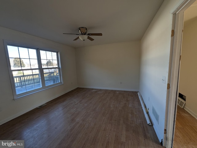 empty room featuring ceiling fan and dark hardwood / wood-style flooring