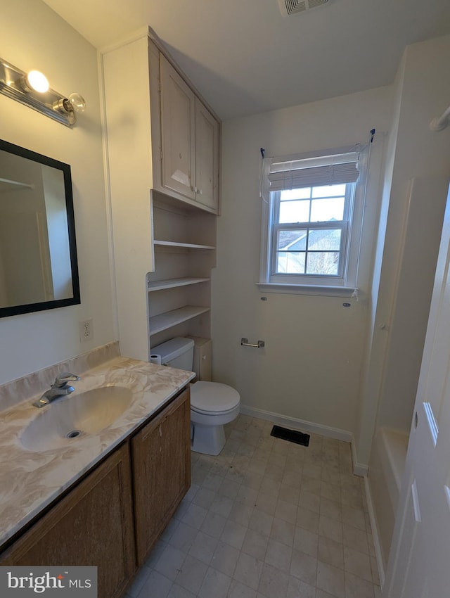 bathroom featuring vanity and toilet