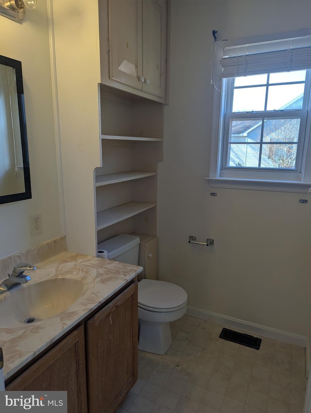 bathroom featuring vanity and toilet