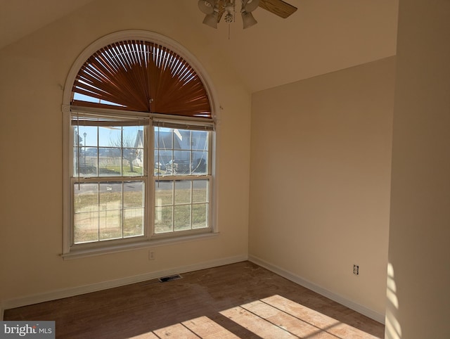 empty room with ceiling fan and lofted ceiling