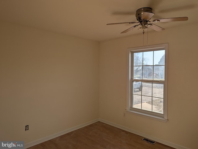 empty room featuring ceiling fan and hardwood / wood-style floors