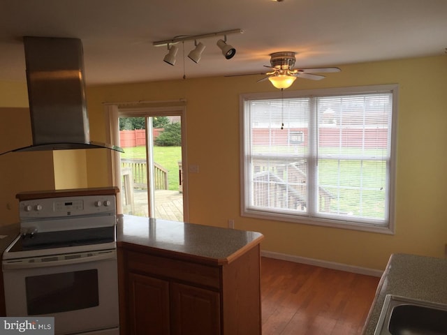 kitchen with ventilation hood, white range with electric stovetop, ceiling fan, and plenty of natural light