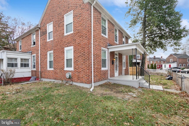 view of side of home with a yard