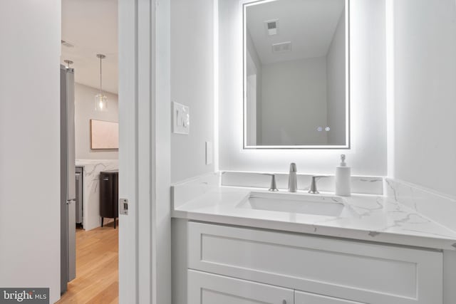 bathroom with vanity and hardwood / wood-style flooring