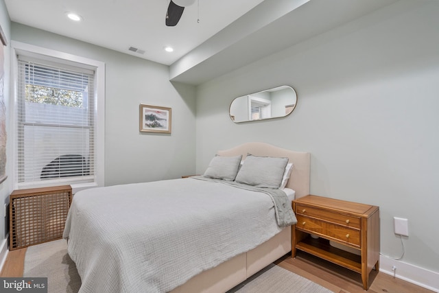 bedroom with light wood-type flooring and ceiling fan