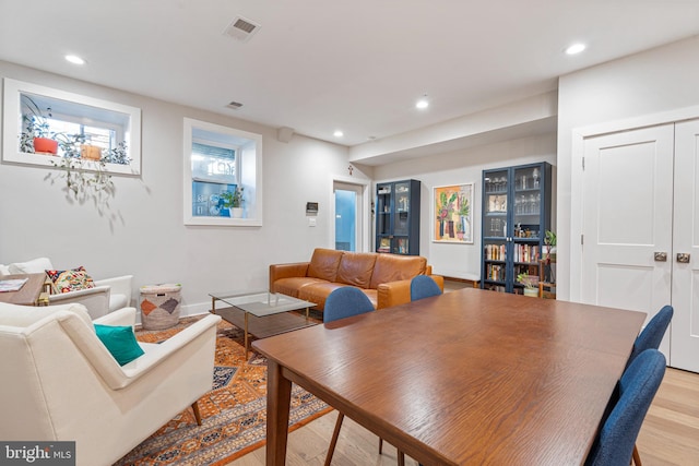 dining space with light hardwood / wood-style floors