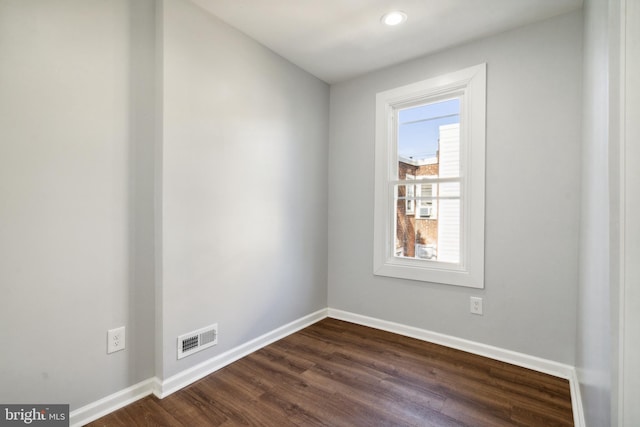 spare room featuring dark hardwood / wood-style floors